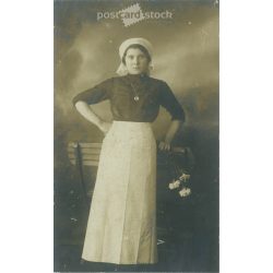   Middle class young woman with flowers. Studio shot, photo sheet. 1920s, 1930s. (2791798)