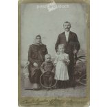 Photographic studio of Ágoston Schmidt, Budapest. Middle-class, full-family, studio photo of a family with two children. Cabinet photo / hardback photo / business card. (2791917)