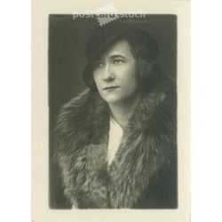   A portrait photo of a fashionably dressed young woman from the 1930s. Hat and fur coat. Original paper image. Studio shot. (2791941)