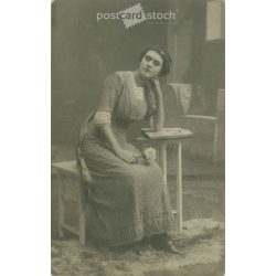   circa 1920 - Middle class young woman with flowers. Studio shot, photo sheet. (2791798)