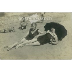   Ladies sunbathing on the beach with umbrella and bystanders. Original paper image. Postcard, photo card. (2792028)