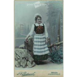   1902 - F.E. Bednarik photographic studio, Vienna. Full-length photo of a young woman in festive, folk attire. Colored  Cabinet card / CDV photo / hardback photo. (2792098)