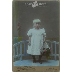   1911 - Ferdinand Kral photographic studio, Vienna. Full-length studio photo. Little girl with a basket.  Cabinet card / CDV photo / hardback photo. (2792105)