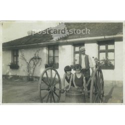  1927 - Bath, in the tub of the water barrel. Dad and the girls. Original paper image. Its maker is unknown. (2792226)