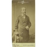 1890s. Man in jacket with cigar, studio shot. It was made by Sterlisky’s photography studio in Budapest. Original  Cabinet card / CDV photo / hardback photo. Cut. (2792230)