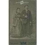 1910s. Full-length studio portrait of a married couple. Made in Hunnia’s photography studio, Budapest. Original  Cabinet card / CDV photo / hardback photo. (2792268)