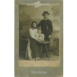 1910s. Studio portrait of a married couple with their child, full-length. Made in the Papír Speed Photography studio, Városloget, Budapest. Original  Cabinet card / CDV photo / hardback photo. (2792269)