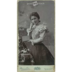   Late 1890s. Unknown young woman with book in hand, full length photo. It was made in the photography studio of Mai and Társa. Budapest. Original  Cabinet card / CDV photo / hardback photo. (2792280)