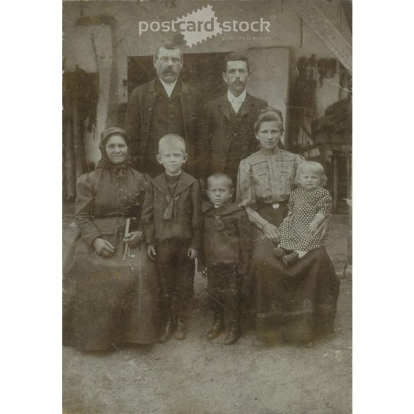 Early 1900s. Family group photo in the yard. The persons in the picture are unknown. It was taken in the photo studio of Illés Wucsetics in Budapest. Covered on hardboard. Cabinet photo / hardback photo / business card. (2792314)