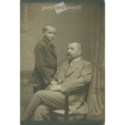   Early 1900s. Studio shot of father and son. Their identities are unknown. The photo. It was taken in the photographic studio of István Goszleth and his Son, in Budapest. Original  Cabinet card / CDV photo / hardback photo. (2792351)