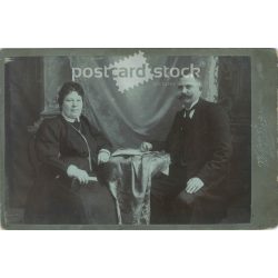   Late 1890s. Studio photo of a middle-aged couple. The persons in the picture are unknown. The photo was taken in the photography studio of Weimann and Billner in Budapest. Original  Cabinet card / CDV photo / hardback photo. (2792356)
