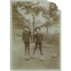   Early 1900s. A pair of brothers, wearing the same outfit. Black and white original paper image, old photo. The creator of the image is unknown. (2792410)