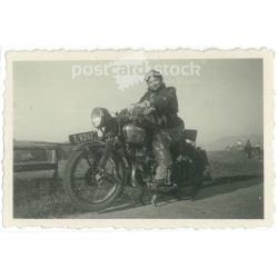   1951 – Germany. Road photo of a lady on a motorcycle. Its maker is unknown. Black and white original paper image, old photo. (2792418)