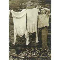   1950s. Germany. Rolling clothes. Published by Gutsch Verlag, Berlin. Cut out postcard. Black and white reprint from an old photo. (2792450)