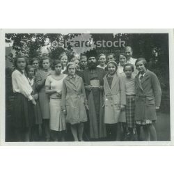   1932. Germany. Young girls with priest. Black and white original paper image, old photo. (2792463)