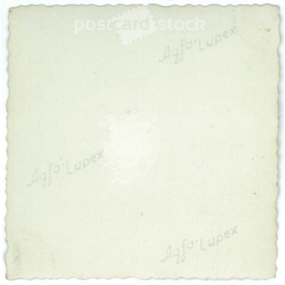 1920s. Germany. Young man sitting on the car in front of the shed. Black and white original paper image, old photo. (2792474)