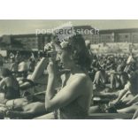 1950s. Germany. Young woman taking photo on the beach. Black and white original paper image, old photo. (2792488)