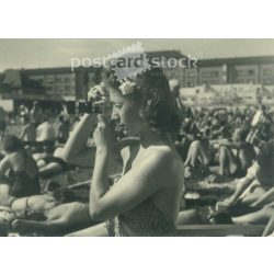   1950s. Germany. Young woman taking photo on the beach. Black and white original paper image, old photo. (2792488)