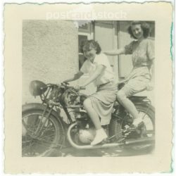   1950. Germany. Young ladies on a stationary motorcycle. The picture was taken by Foto-Uschold. Black and white original paper image, old photo. (2792489)