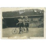 1943. Germany. Children on bicycles on a farm. The creator of the picture and the person on it are unknown. Black and white original paper image, old photo. (2792498)