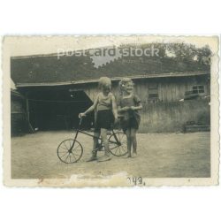   1943. Germany. Children on bicycles on a farm. The creator of the picture and the person on it are unknown. Black and white original paper image, old photo. (2792498)