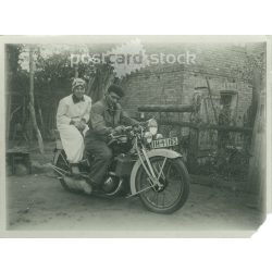   1920s. Germany. Young couple posing on a motorcycle. The creator of the picture and the identity of the people on it are unknown. Black and white original paper image, old photo. (2792518)