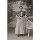 1917 - Pretty lady with flowers and Bible, studio recording. The creator of the image is unknown. Original paper image. Old photo. Black and white photo sheet, postcard. (2792563)