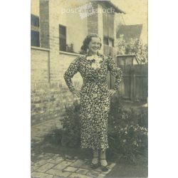   1930s. In a floral dress. The creator of the picture and the person on it are unknown. Original paper image. Old photo. Black and white photo sheet, old postcard. (2792595)