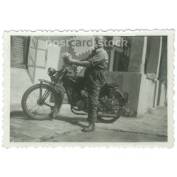  1930s. Biker with a puppy. The creator of the picture and the person on it are unknown. Original paper image. Old photo. (2792656)