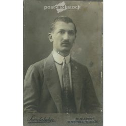   Early 1900s. Studio photo of a young man. The person in the picture is unknown. The work of the photography studio in Szerdahely. Budapest. Old photo, business card, CDV photo. (2792703)