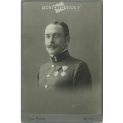   Early 1900s. Studio photo of a soldier with decorations. The person in the picture is unknown. The work of the Sig Bing photography studio. Vienna. Old photo, original cabinet photo / hardback photo. (2792723)