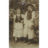 In folk costume. The persons in the picture are unknown. Original paper image. Old photo. Black and white photo sheet, old postcard. (2792754)