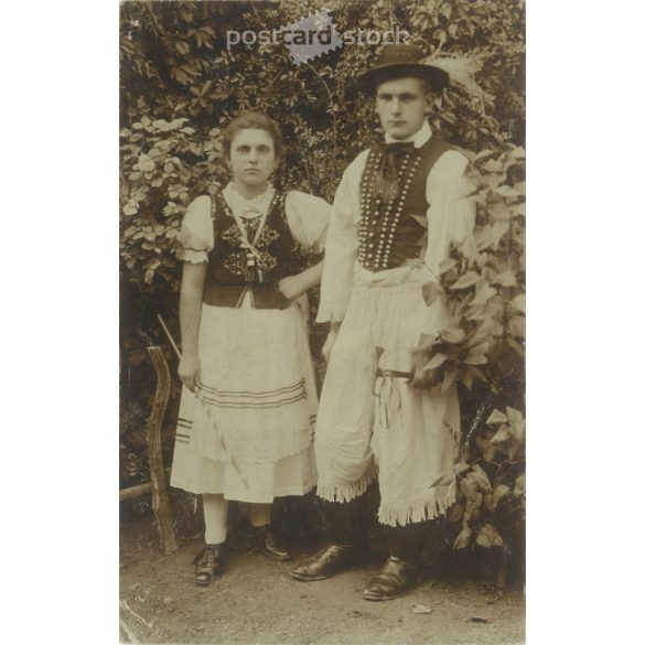 In folk costume. The persons in the picture are unknown. Original paper image. Old photo. Black and white photo sheet, old postcard. (2792754)