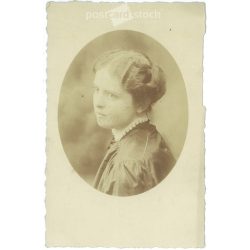   Around 1910 - Studio portrait photo of a young woman. The subject and the photographer are unknown. Original old photo. Black and white photo, old postcard. (2792805)