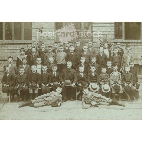 Class photo with cap. The people in the photo and the photographer are unknown. Original old photo. Black and white, laminated photo, original paper photo. (2792812)