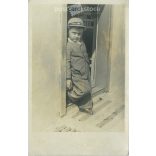 A little boy in the sun. The subject and the author of the picture are unknown. Original paper image, black and white photo sheet, postcard. (2792911)