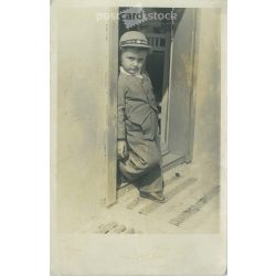   A little boy in the sun. The subject and the author of the picture are unknown. Original paper image, black and white photo sheet, postcard. (2792911)