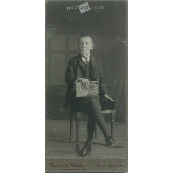 Studio photo of an unknown young boy. The photo was taken in the Ferentzy and Kováts photo studio in Székely-Udvarhely. Old photo / Cabinet photo / hardback photo. (2792984)