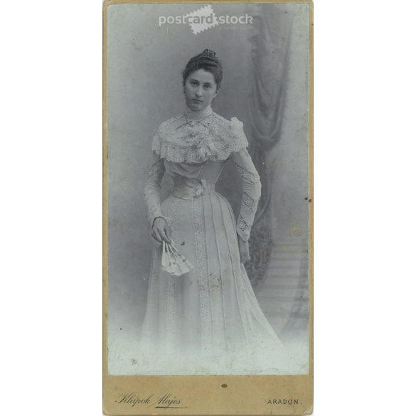 Studio full-length photo of an elegant young lady. The identity of the subject is unknown. The photo was taken in the studio of Alajos Klapok in Arad. Old photo / Cabinet photo / Hardback photo (2793012)
