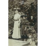 1910s. Young woman with her little daughter and a secret admirer. The people in the picture and the photographer are unknown. Original photo. Black and white photo card, postcard. (2793432)