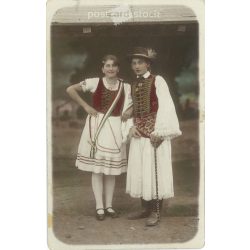  1910s. Young couple in folk costumes, Martonvásár. The people in the picture and the photographer are unknown. Original old photo. Colored photo, old postcard. (2793611)