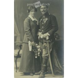   1910s. Studio photo of a young couple. The people in the photo and the photographer are unknown. Original old photo. Black and white photo, old postcard. (2793614)