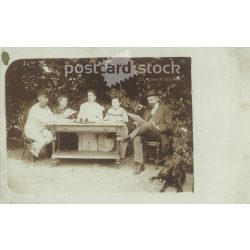   Afternoon rest in the garden. The person in the picture and the photographer are unknown. Original old photo. Black and white photo, old postcard. (2793634)