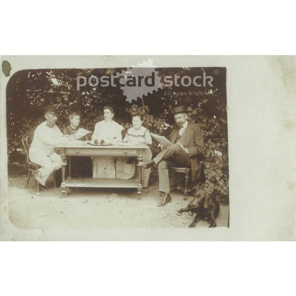 Afternoon rest in the garden. The person in the picture and the photographer are unknown. Original old photo. Black and white photo, old postcard. (2793634)