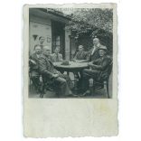 Around a table. The people in the picture and the photographer are unknown. Old photo. Black and white photo, original paper image. (2793635)