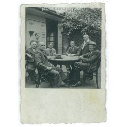   Around a table. The people in the picture and the photographer are unknown. Old photo. Black and white photo, original paper image. (2793635)