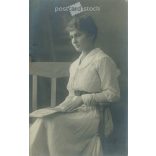 Young woman in white, studio shot. Gelatin silver. The person in the picture and the photographer are unknown. Original old photo. Black and white photo card, old postcard. (2793641)
