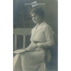   Young woman in white, studio shot. Gelatin silver. The person in the picture and the photographer are unknown. Original old photo. Black and white photo card, old postcard. (2793641)