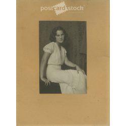   1968 - Young woman in white, studio shot. The person in the photo and the photographer are unknown. Original old photo. Black and white, laminated photo, original paper image. (2793645)