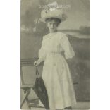1910 - Young woman in summer clothes, studio shot. The person in the picture and the photographer are unknown. Original old photo. Black and white photo, old postcard. (2793648)